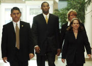 L.A. Lakers' star Kobe Bryant accompanied by his attorney Pamela Mackey, right, and security, enters court at the Justice Center for a pretrial motions hearing Tuesday, May 11, 2004 in Eagle Co. Bryant is appearing in Eagle County District Court facing charges of sexual assault. (AP Photo/Ed Andrieski)