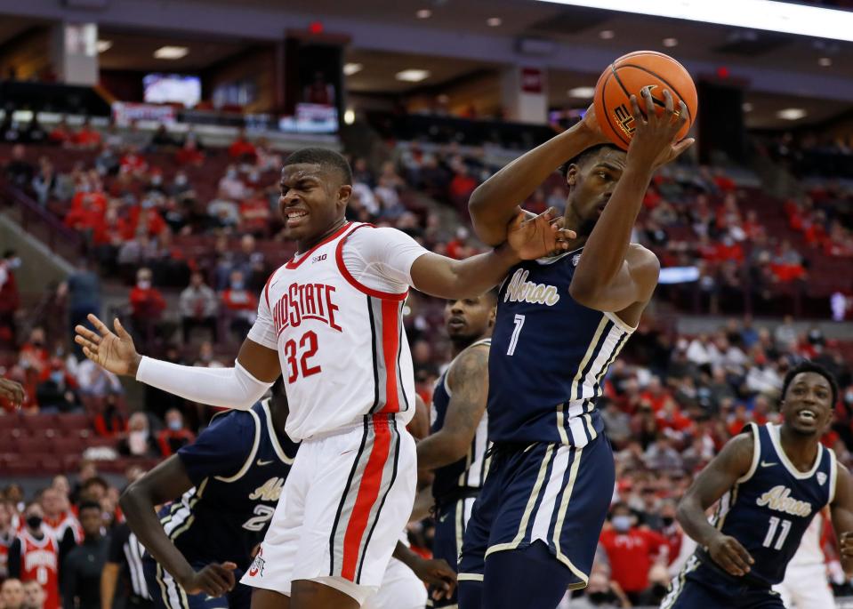 Akron Zips guard K.J. Walton (1) grabs a rebound away from Ohio State Buckeyes forward E.J. Liddell (32) during the second half of the NCAA men's basketball game at Value City Arena in Columbus on Tuesday, Nov. 9, 2021. The Buckeyes won 67-66.