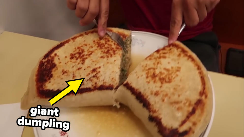 A man is eating a giant dumpling