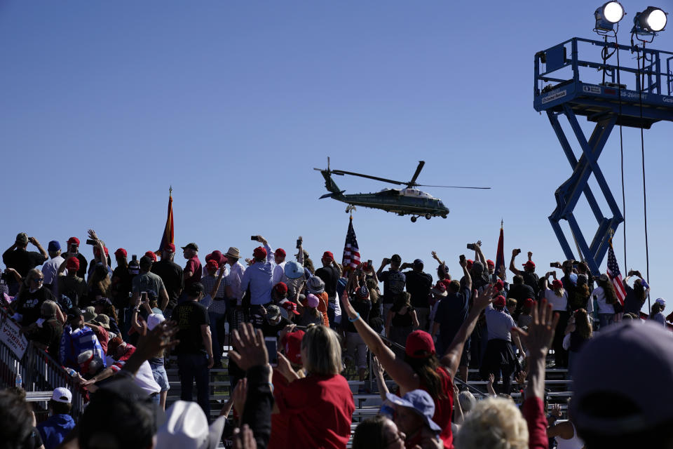 Supporters cheer as Marine One with President Donald Trump departs after a campaign rally at Prescott Regional Airport, Monday, Oct. 19, 2020, in Prescott, Ariz. (AP Photo/Alex Brandon)