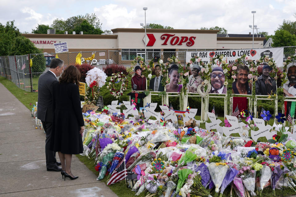 FILE - Vice President Kamala Harris and her husband Doug Emhoff visit a memorial near the site of the Buffalo supermarket shooting after attending a memorial service for Ruth Whitfield, one of the victims of the shooting, on May 28, 2022, in Buffalo, N.Y. Payton Gendron, the white gunman who pleaded guilty to state charges in the massacre of 10 Black people at the Buffalo supermarket, would be willing plead guilty to federal charges if spared the death penalty, his lawyer said in court Friday, Dec. 9. (AP Photo/Patrick Semansky, File)