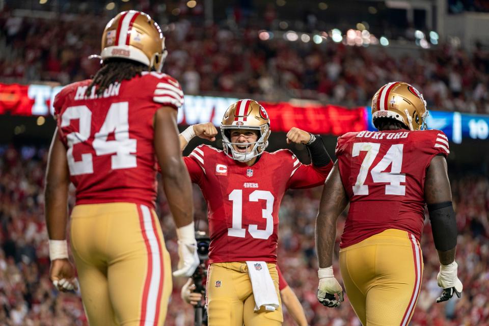 San Francisco 49ers quarterback Brock Purdy, center, celebrates a touchdown against the Dallas Cowboys in the fourth quarter of Sunday night's win.