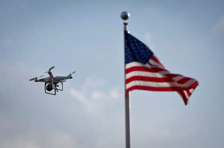 FILE PHOTO: A small drone helicopter flies over Coney Island in New York, U.S., August 29, 2013. REUTERS/Carlo Allegri/File Photo