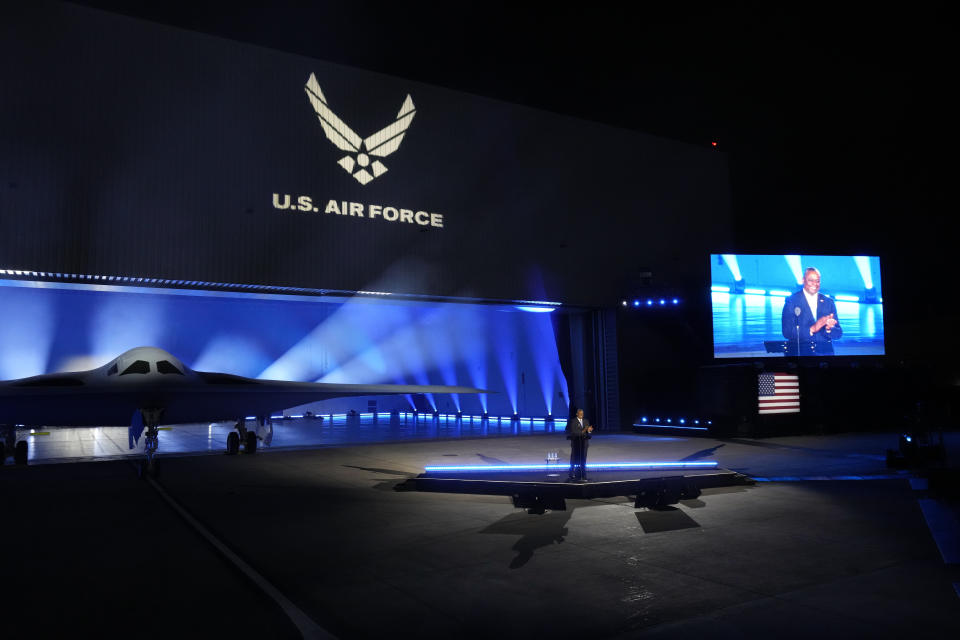 Secretary of Defense Lloyd Austin introduces the B-21 Raider stealth at Northrop Grumman Friday, Dec. 2, 2022, in Palmdale, Calif. America’s newest nuclear stealth bomber made its debut Friday after years of secret development and as part of the Pentagon’s answer to rising concerns over a future conflict with China. The B-21 Raider is the first new American bomber aircraft in more than 30 years. Almost every aspect of the program is classified. (AP Photo/Marcio Jose Sanchez)