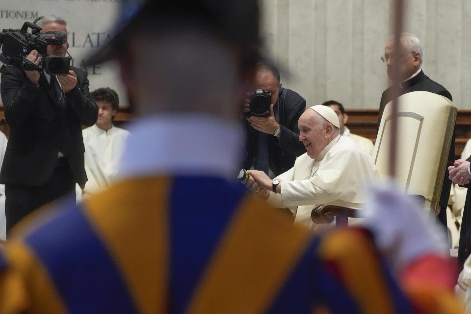 Pope Francis, framed by a Swiss guard, meets with pilgrims from Concesio and Sotto il Monte on the 60th anniversary of the death of Pope John XXIII and the election of Paul VI in St. Peter's Basilica at the Vatican, Saturday, June 3, 2023. Pope Francis warned the Vatican's missionary fundraisers on Saturday to not allow financial corruption to creep into their work, insisting that spirituality and spreading the Gospel must drive their operations, not mere entrepreneurship. (AP Photo/Gregorio Borgia)