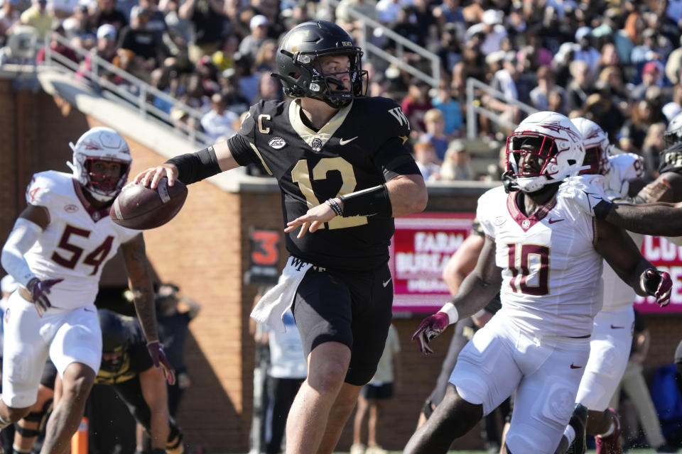 Wake Forest quarterback Mitch Griffis (12) looks to pass against Florida State during the first half of an NCAA college football game in Winston-Salem, N.C., Saturday, Oct. 28, 2023. (AP Photo/Chuck Burton)