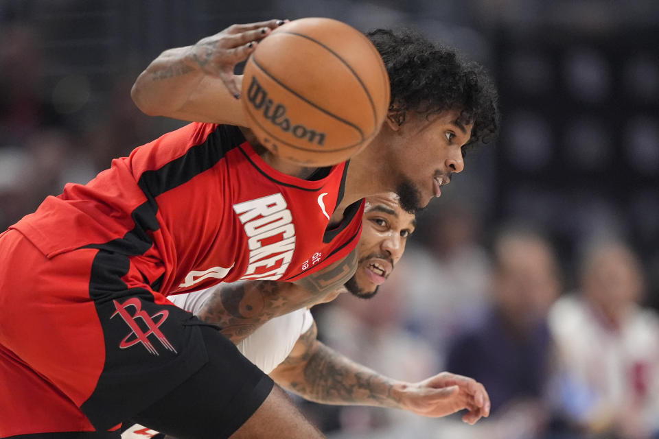 Houston Rockets guard Jalen Green, left, drives toward the basket as Los Angeles Clippers guard Xavier Moon defends during the first half of an NBA basketball game Sunday, April 14, 2024, in Los Angeles. (AP Photo/Mark J. Terrill)