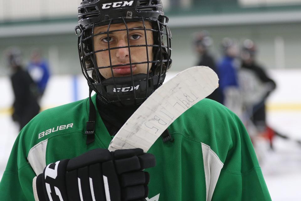 Wayland High School sophomore Sam Brande shows the blade of his stick, which he uses to honor his friend Teddy Balkind, Jan. 14, 2022.