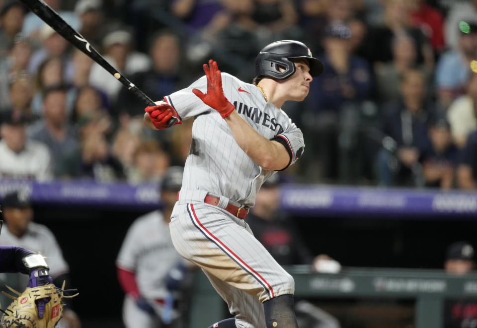 Minnesota Twins' Max Kepler follows the flight of his RBI sacrifice fly off Colorado Rockies relief pitcher Tyler Kinley in the ninth inning of a baseball game Friday, Sept. 29, 2023, in Denver. (AP Photo/David Zalubowski)