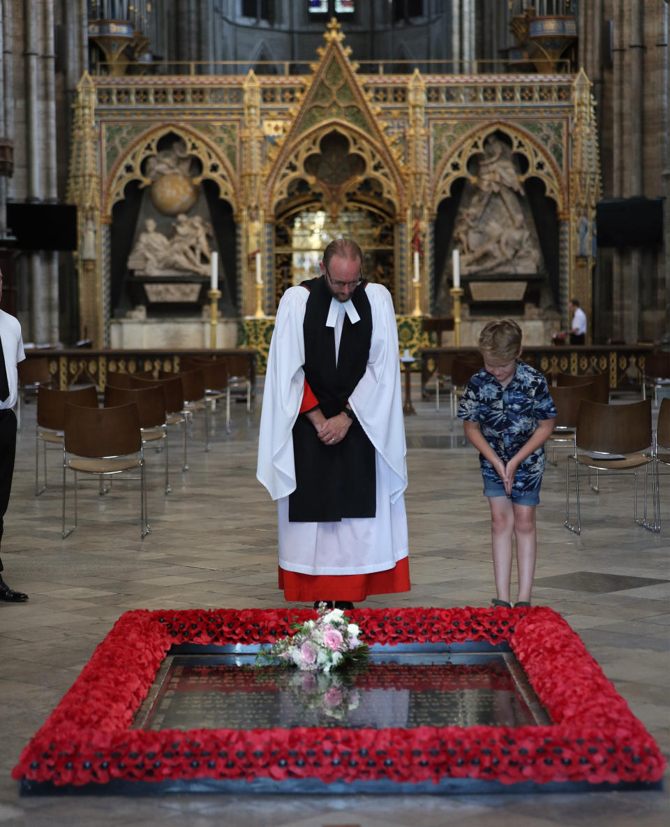 Embargoed: Not for publication or onward transmission before 2200 BST Saturday July 18, 2020. NEWS EDITORIAL USE ONLY. NO COMMERCIAL USE. NO MERCHANDISING, ADVERTISING, SOUVENIRS, MEMORABILIA or COLOURABLY SIMILAR. Reverend Anthony Ball, Canon of Westminster in Westminster Abbey in London with Toby Wright, son of the Reverend Paul Wright, Sub-Dean of the Chapel Royal, who brought Princess Beatrice's wedding bouquet straight from the wedding in Windsor which, like those of Royal brides, is traditionally placed on the Tomb of the Unknown Warrior.