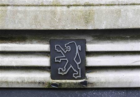 The Peugeot logo is seen on a vehicle at an auto junkyard in Vendenheim near Strasbourg, November 27, 2013. Picture taken November 27, 2013. REUTERS/Vincent Kessler