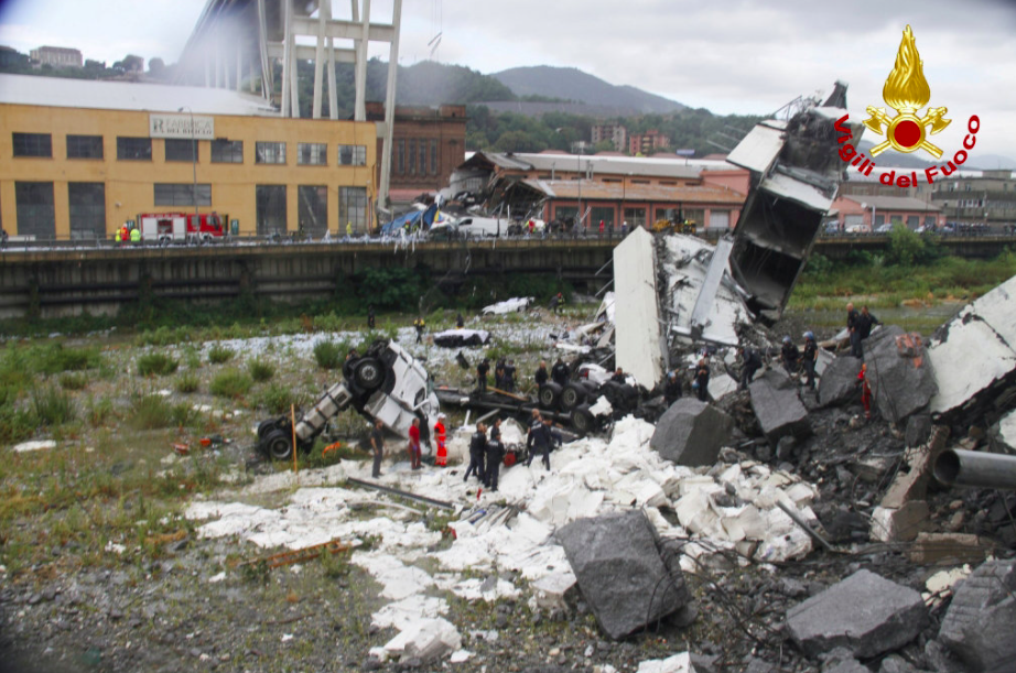 <em>Vehicles can be seeing lying devastated on the ground following the bridge collapse (Reuters)</em>