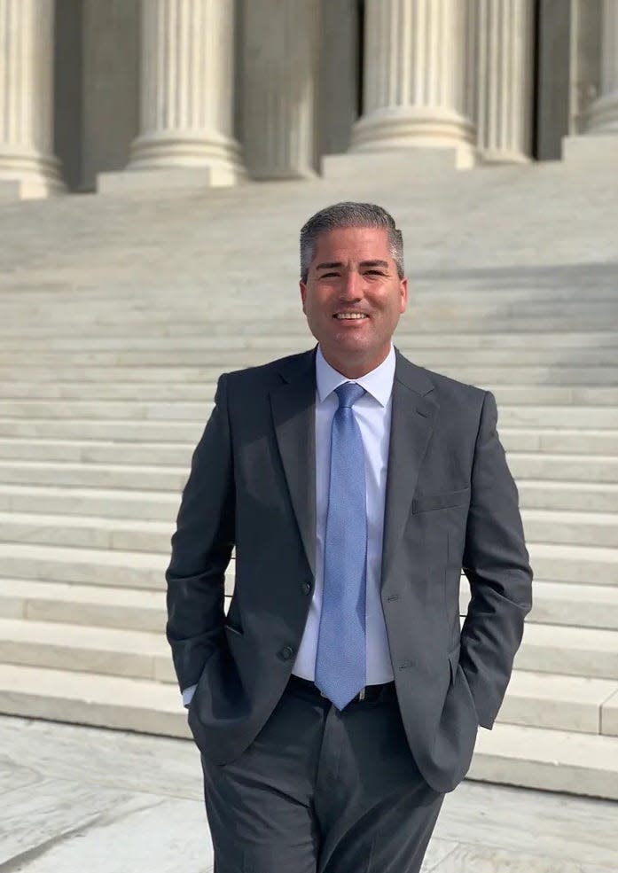 Port Huron City Manager James Freed stands on the steps of the U.S. Supreme Court at the end of October in Washington, D.C.