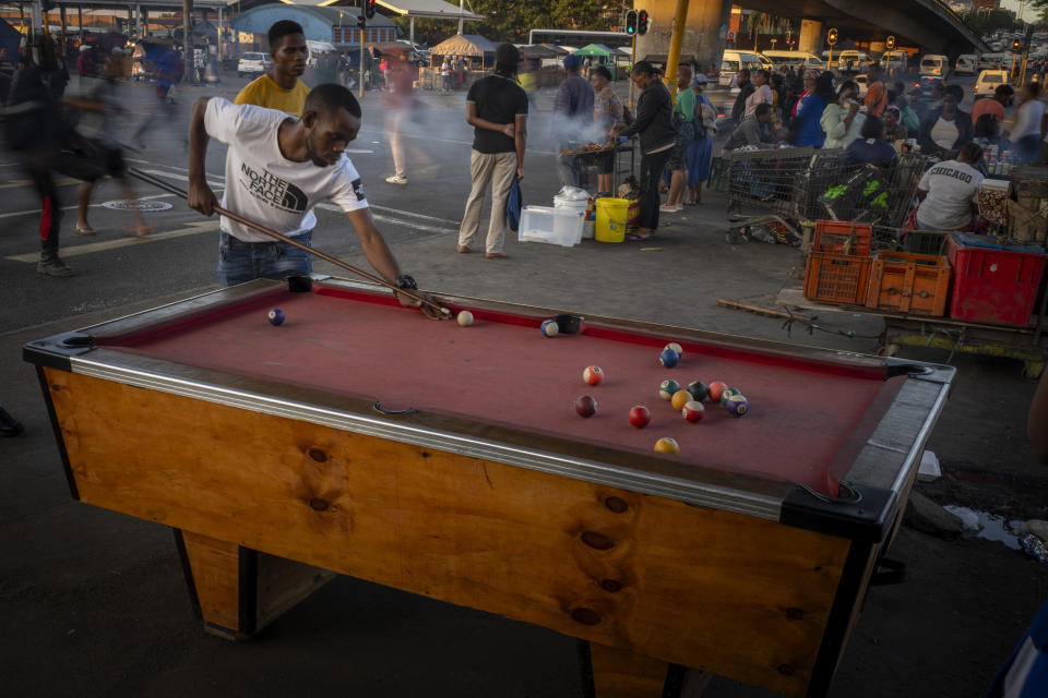 Men plays billiards in downtown Durban , South Africa, Monday, May 27, 2024. (AP Photo/Emilio Morenatti)