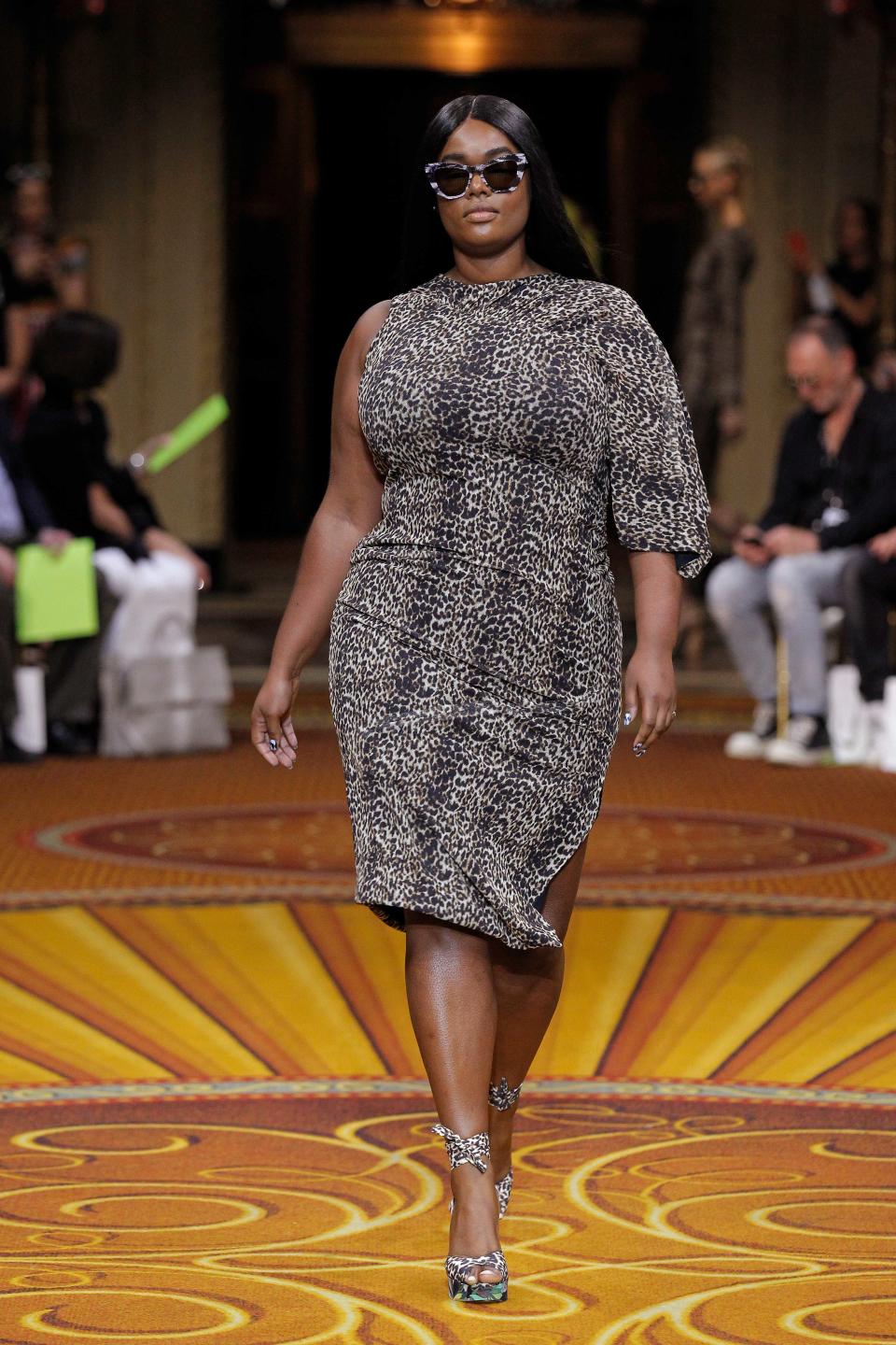 <p>A plus-size model walks Christian Siriano’s runway wearing a leopard print dress, matching heels, and cat-eye sunglasses during New York Fashion Week. (Photo: Getty Images) </p>