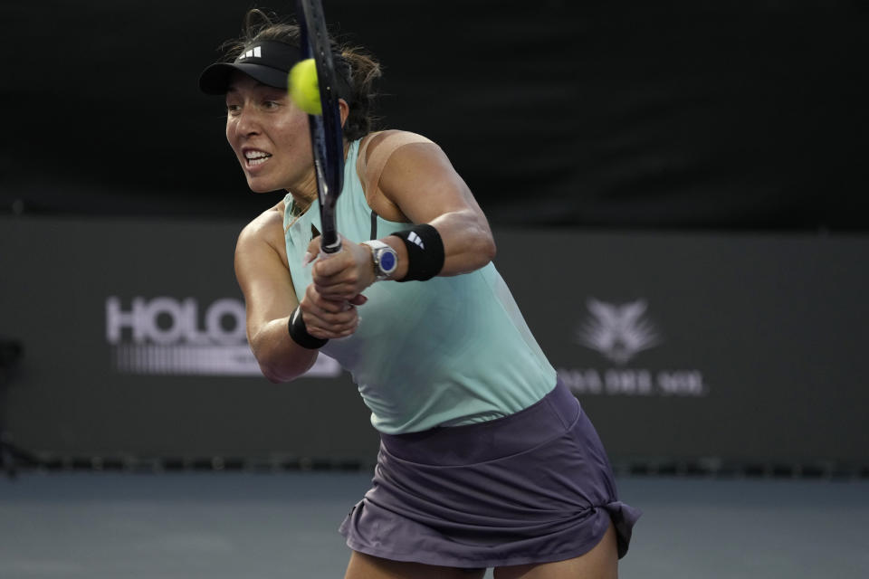 Jessica Pegula, of the United States, returns the ball during a women's singles final of the WTA Finals tennis championships against Iga Swiatek, of Poland, in Cancun, Mexico, Monday, Nov. 6, 2023. (AP Photo/Fernando Llano)