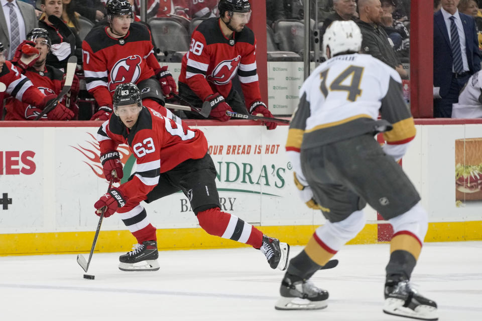 New Jersey Devils left wing Jesper Bratt (63) skates against Vegas Golden Knights defenseman Nicolas Hague (14) during the second period of an NHL hockey game, Monday, Jan. 22, 2024, in Newark, N.J. (AP Photo/Mary Altaffer)