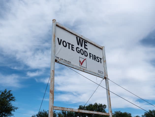 A sign declaring “We Vote God First” sits along a roadside in Snowflake, Arizona. (Photo: Molly Peters for HuffPost)