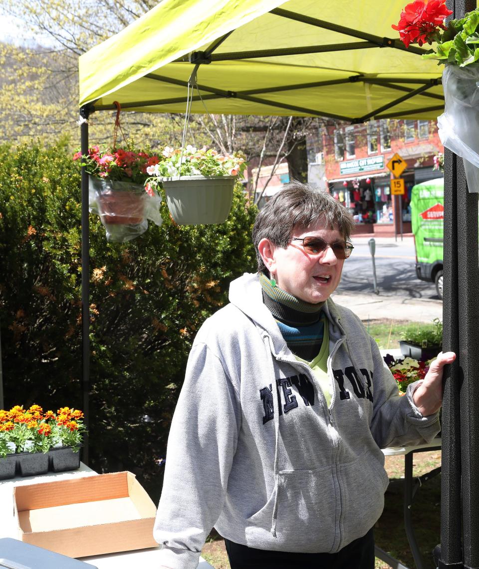 Mary Simonelli helping to run a plant sale outside United Methodist Church in the village of Brewster May 5, 2022. 