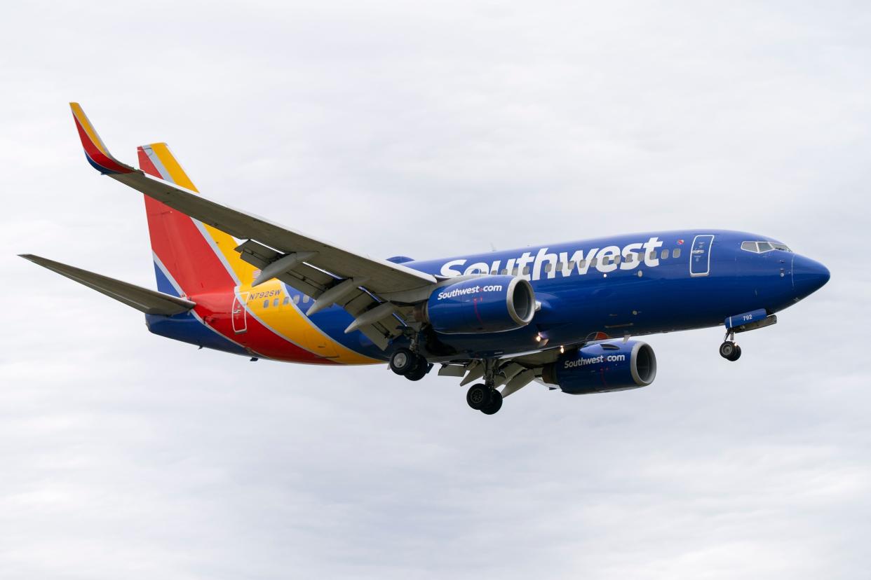 FILE - A Southwest Airlines flight prepares to land at Reagan National Airport, in Arlington, Va., Monday, Dec. 27, 2021.  (AP Photo/Jacquelyn Martin, File)