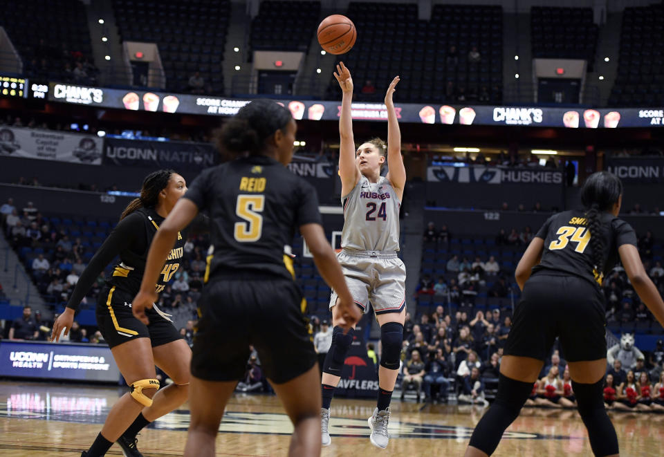 Connecticut's Anna Makurat (24) shoots as Wichita State's Asia Henderson (42), Wichita State's Ashley Reid (5), and Wichita State's Shyia Smith (34) defend during the second half of an NCAA college basketball game Thursday, Jan. 2, 2020, in Hartford, Conn. (AP Photo/Jessica Hill)