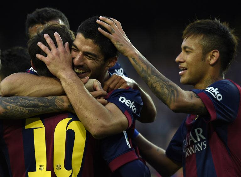 Barcelona forwards Luis Suarez (C), Neymar (R) and Lionel Messi (L) celebrate after scoring a goal during the Spanish league football match against Getafe in Barcelona on April 28, 2015