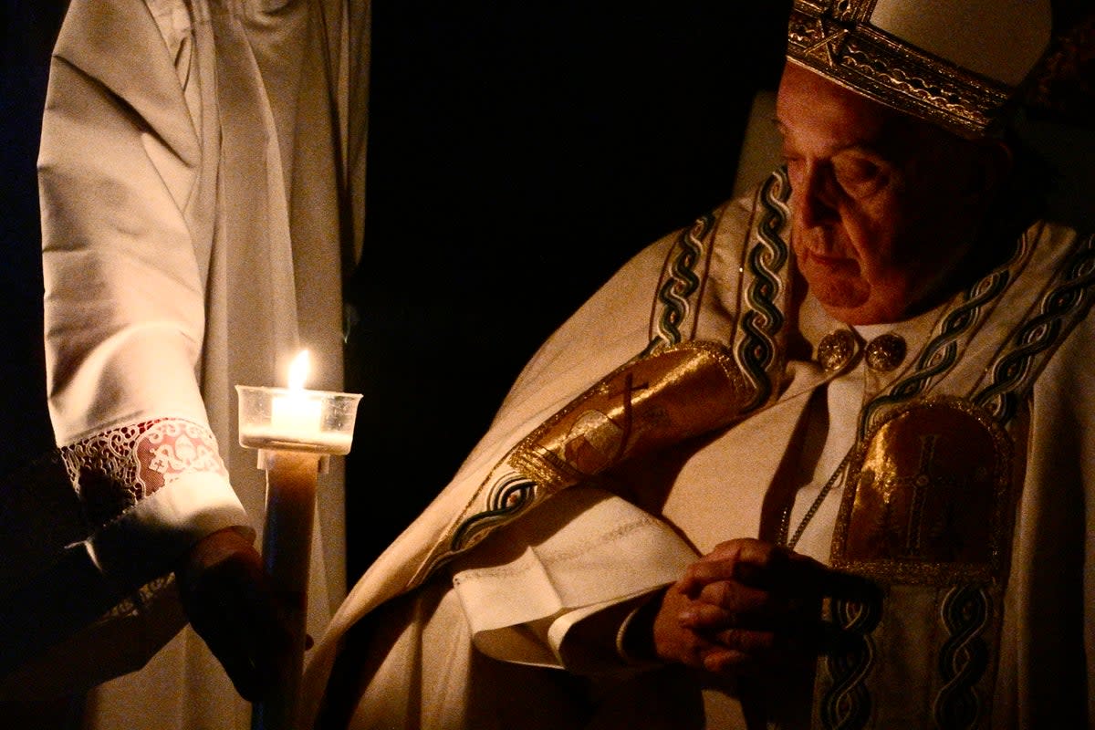 Pope Francis looks at his candle during the Easter Vigil (AFP/Getty)