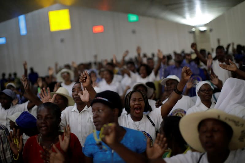 Faithful pray at Christ Roi church before a march organised by religious leaders in Port-au-Prince