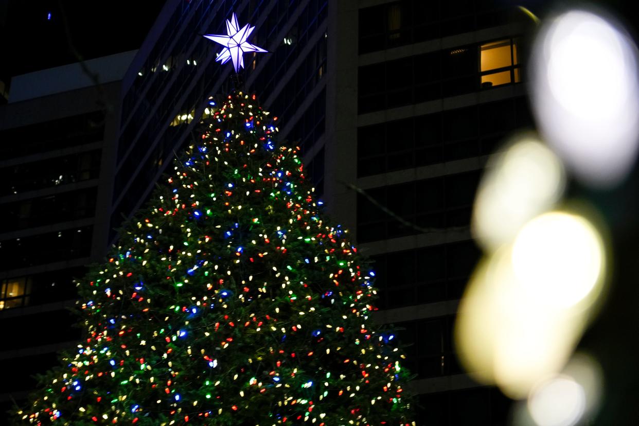 Colorful lights are wrapped around Fountain Square’s live Christmas tree on Thursday, Dec. 21, 2023, in downtown Cincinnati.