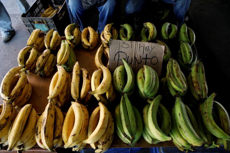 FILE PHOTO: A sign that reads "There is a point" referring to the availability of a point-of-sale (POS), is seen in a bananas street vendor stall in Caracas