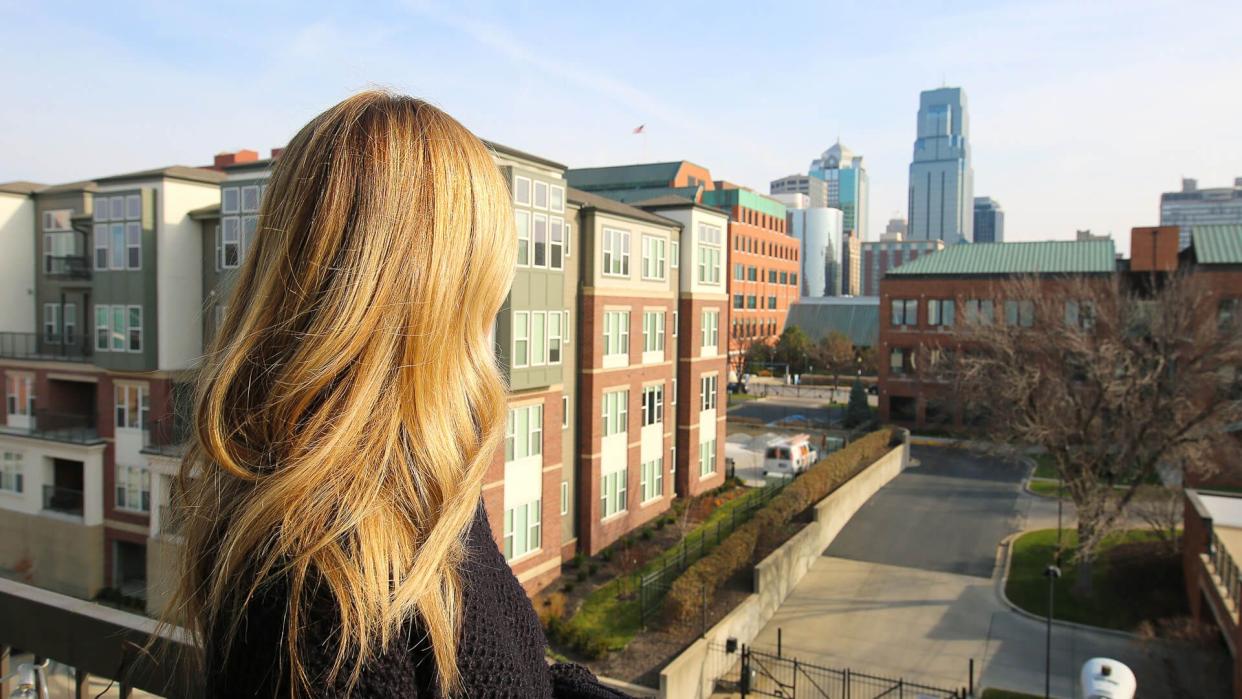 blonde looking at KC skyline.