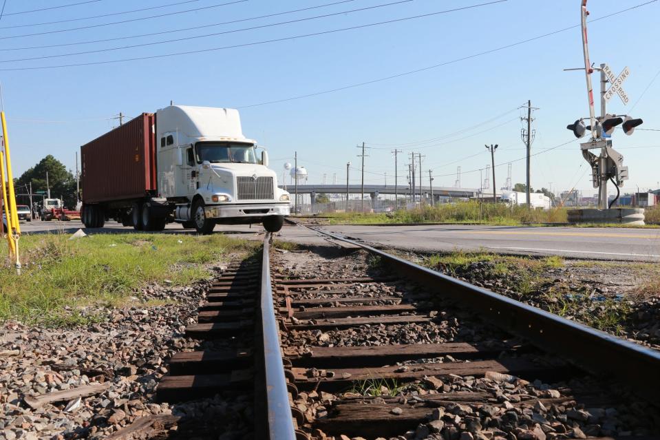 A semitractor-trailer crosses the railroad track near the entrance to the Georgia Ports Authority in Garden City. About three times a day trains will block Georgia 25 as well as access to residential areas.