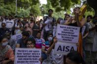 Activists hold placards as they participate in a protest demonstration against remission of sentence by the government to convicts of a gang rape of a Muslim woman, in New Delhi, India, Saturday, Aug. 27, 2022. The victim, who is now in her 40s, was pregnant when she was brutally gang raped in communal violence in 2002 in the western state of Gujarat, which saw over 1,000 people, mostly Muslims, killed in some of the worst religious riots India has experienced since its independence from Britain in 1947. (AP Photo/Altaf Qadri)