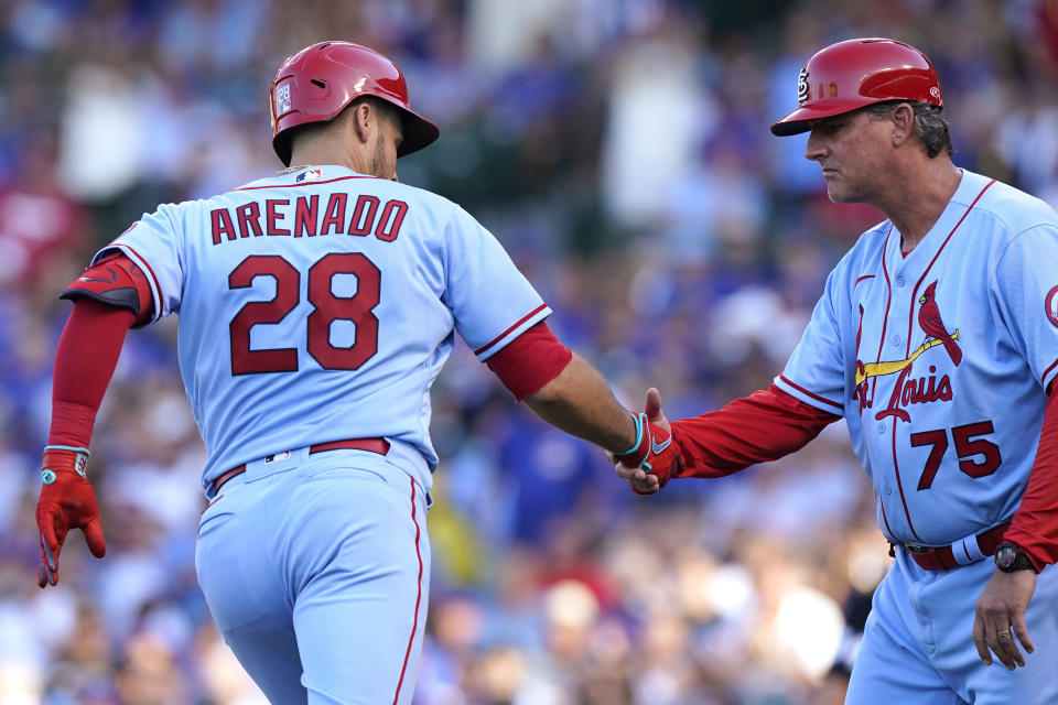 St. Louis Cardinals' Nolan Arenado, left, is congratulated by third base coach Ron 'Pop' Warner after hitting a solo home run during the second inning of the team's baseball game against the Chicago Cubs in Chicago, Saturday, June 12, 2021. (AP Photo/Nam Y. Huh)