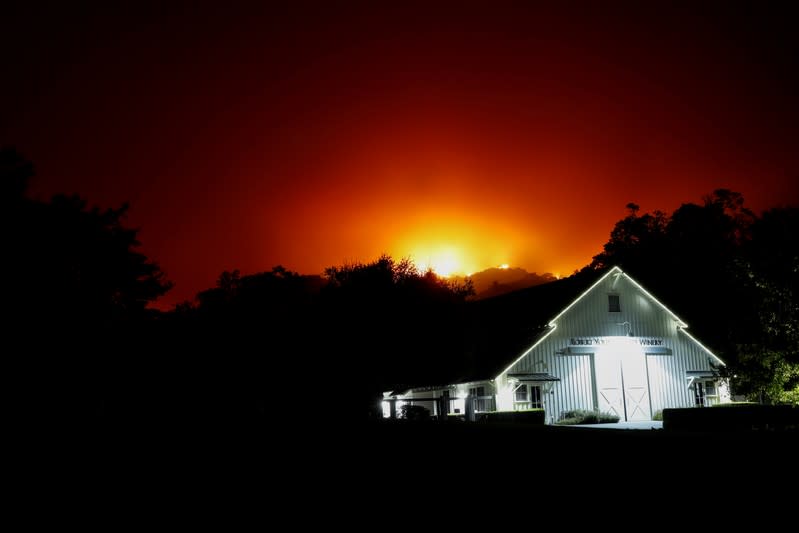 FILE PHOTO: The Robert Young Estate Winery is seen as the Kincade fire burns in the distance, in Geyserville, California