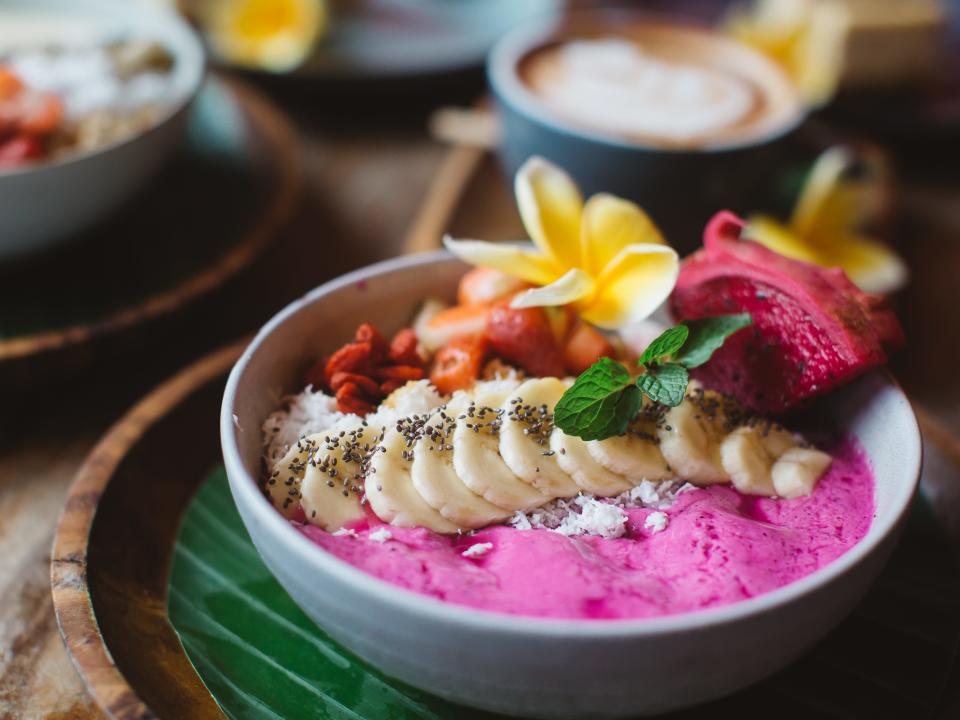 acai bowl with a flower, sliced bananas on top