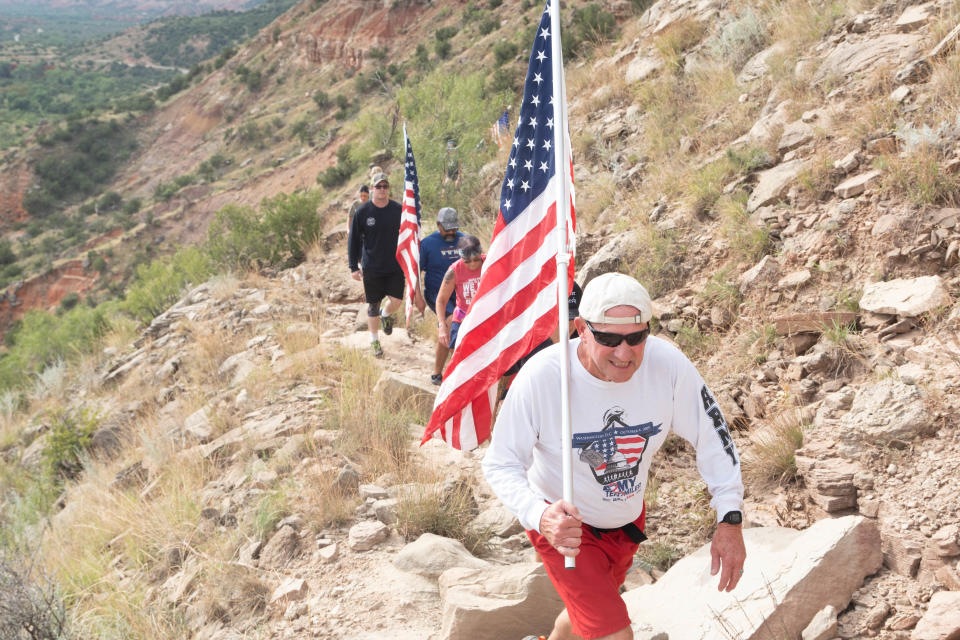 Retired Army Major Doug Messer leads his team up the trail Saturday morning at the Iwo Jima Flag Run at Palo Duro Canyon.