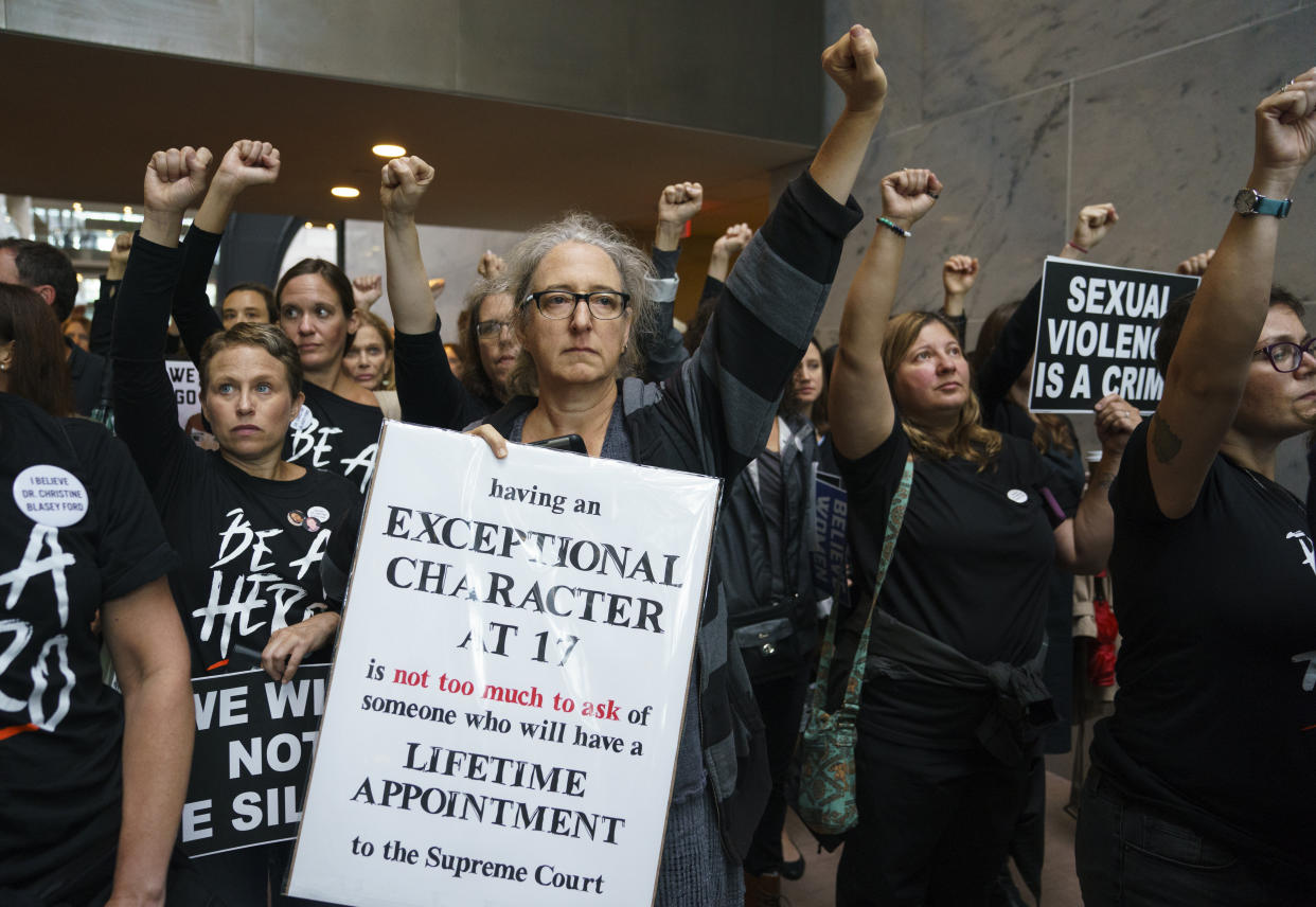 Protesters opposed to Supreme Court nominee Brett Kavanaugh stand quietly with fists raised in the Hart Senate Office Building on Capitol Hill in Washington, D.C., on Sept. 24, 2018. (Photo: Carolyn Kaster/AP)