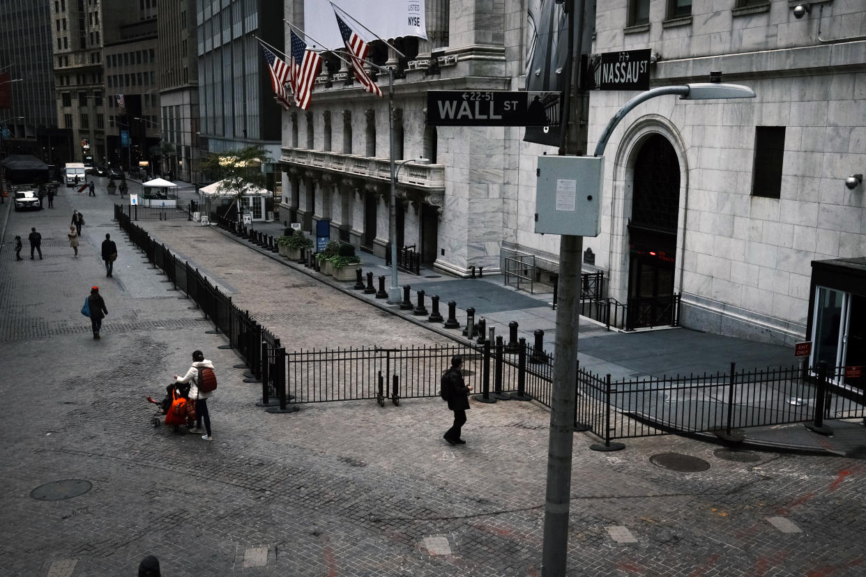 NEW YORK, NEW YORK - OCTOBER 28: People walk by the New York Stock Exchange (NYSE) in Manhattan's financial district on October 28, 2020 in New York City. The Dow Jones Industrial Average fell sharply on Wednesday as fears grow over the worsening situation with the coronavirus pandemic's new wave across Europe and parts of America. Stocks on Wall Street fell over 900 points at the close of the trading day. (Photo by Spencer Platt/Getty Images)