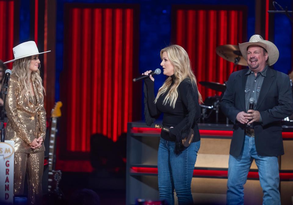 Lainey Wilson is greeted on the Grand Ole Opry stage by Trisha Yearwood and Garth Brooks who inducted her in as the Opry’s newest member Friday, June 7, 2024.