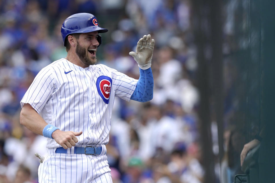 Chicago Cubs' Patrick Wisdom, left, smiles as he celebrates with teammates after scoring on a one-run single by Joc Pederson during the fifth inning of a baseball game against the Miami Marlins in Chicago, Sunday, June 20, 2021. (AP Photo/Nam Y. Huh)