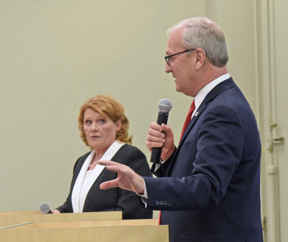 Republican U.S. Rep. Kevin Cramer, front, makes a point as North Dakota Democratic U.S. Sen. Heidi Heitkamp listens during the U.S. Senate Candidate Debate on Thursday night, Oct. 18, 2018, in Bismarck, N.D. The debate was sponsored by the North Dakota Newspaper Association. (Tom Stromme/The Bismarck Tribune via AP)