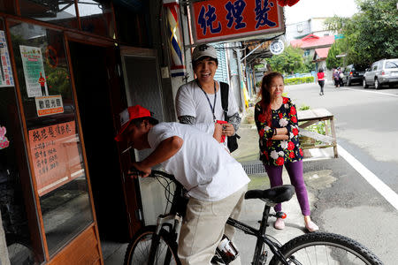 Chen Hong-zhi, 26, who suffers from short-term memory loss, talks to his friend, Sister Jhang in Hsinchu, Taiwan, September 26, 2018. REUTERS/Tyrone Siu