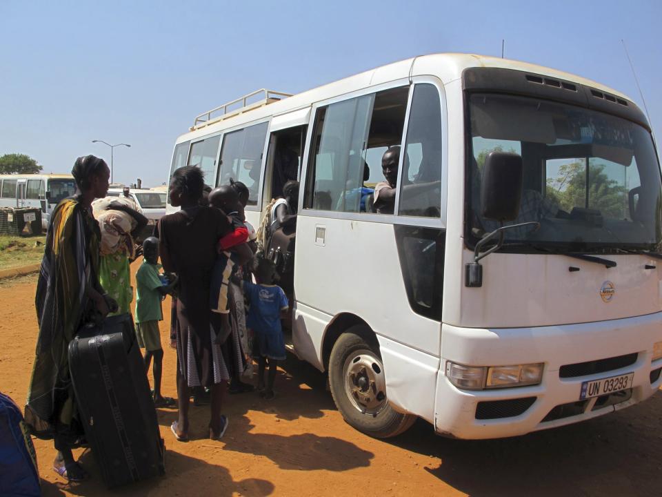 Displaced Sudanese families prepare to board a bus at the United Nations Mission in the Republic of South Sudan (UNMISS) compound, on the outskirts of the capital Juba in South Sudan, in this December 18, 2013 handout photograph from the UNMISS. Fighting between South Sudanese soldiers spread to the flashpoint town of Bor on Wednesday, raising fears of a broader civil conflict in the two-year-old nation. An official in Bor, north of Juba, said soldiers attacked each other at two military barracks and one journalist said troops loyal to Vice President Riek Machar now controlled them, suggesting violence was increasingly running along ethnic lines. REUTERS/UNMISS/Handout via Reuters (SOUTH SUDAN - Tags: CIVIL UNREST POLITICS SOCIETY CONFLICT) ATTENTION EDITORS - THIS IMAGE WAS PROVIDED BY A THIRD PARTY. FOR EDITORIAL USE ONLY. NOT FOR SALE FOR MARKETING OR ADVERTISING CAMPAIGNS. THIS PICTURE IS DISTRIBUTED EXACTLY AS RECEIVED BY REUTERS, AS A SERVICE TO CLIENTS. NO SALES. NO ARCHIVES