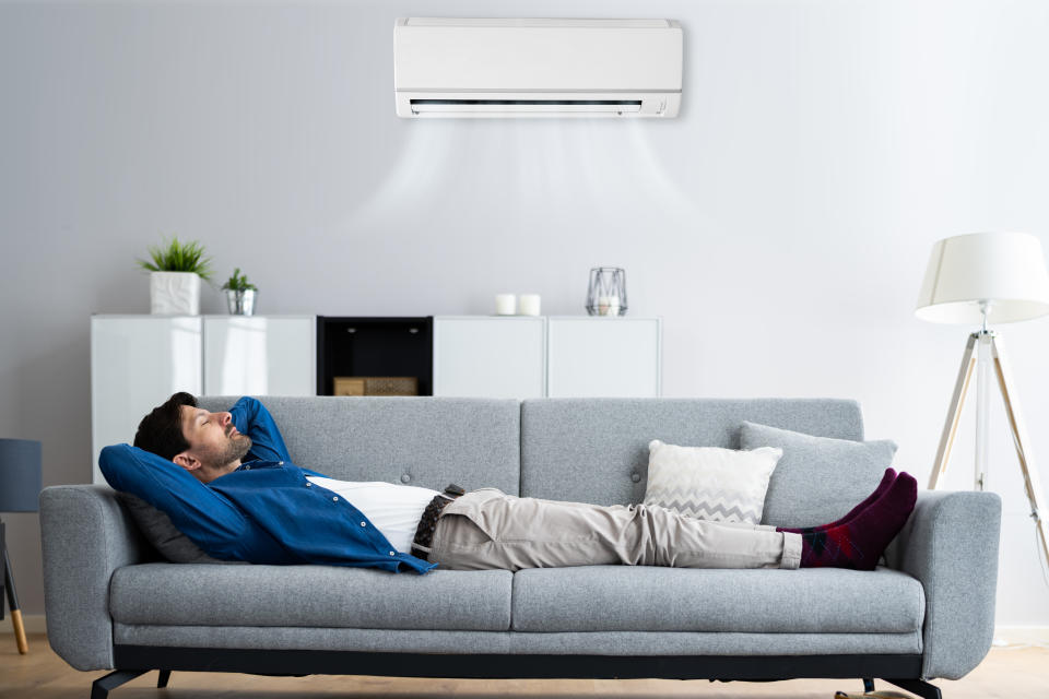 Man with air conditioner at home. (Getty Images)