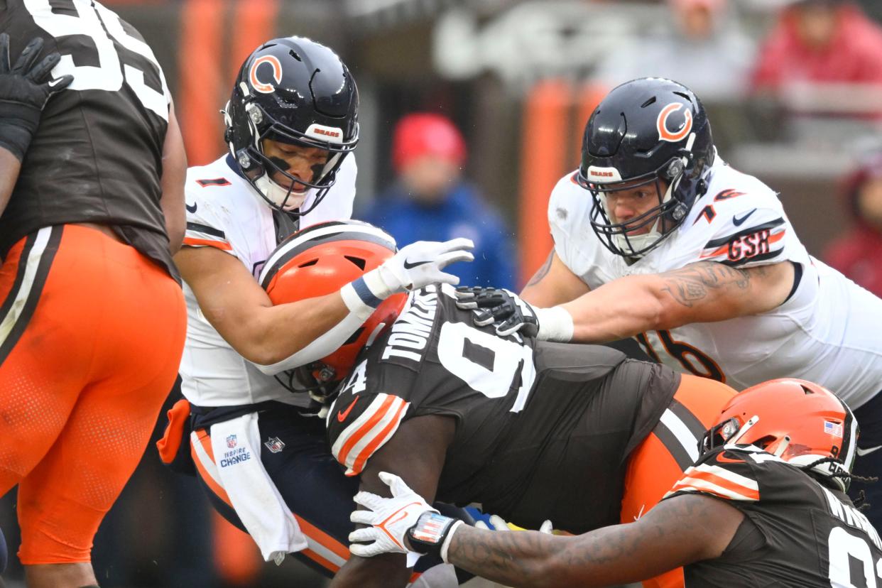 Cleveland Browns defensive tackle Dalvin Tomlinson (94) sacks Chicago Bears quarterback Justin Fields (1) on Dec. 17, 2023, in Cleveland.