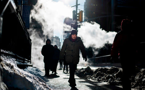 People braving the cold in New York - Credit: AFP