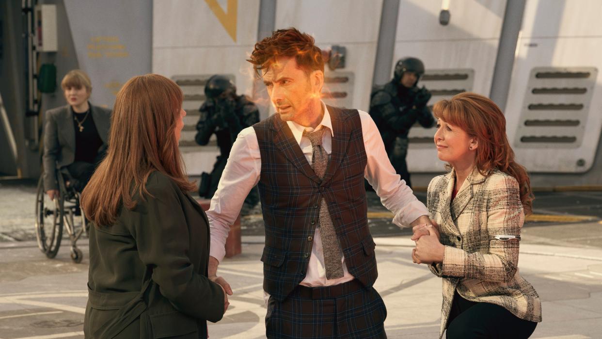  The 14th Doctor holding hands with Donna and Mel in his Doctor Who regeneration scene. 