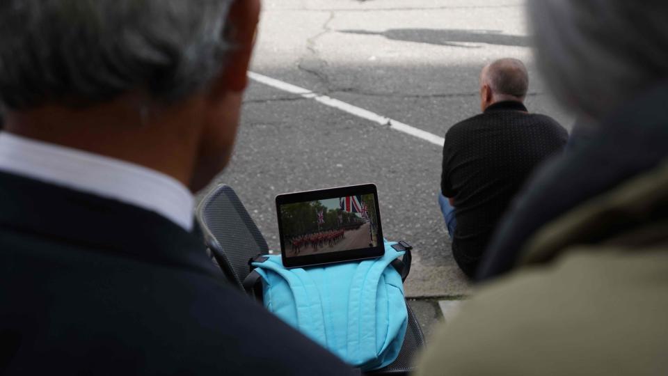 People in line watch the Queen's coffin being moved from Buckingham Palace to Westminster Hall.
