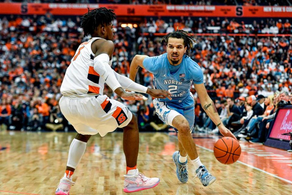 North Carolina guard Cole Anthony (2) is defended by Syracuse forward Quincy Guerrier during the first half of an NCAA college basketball game in Syracuse, N.Y., Saturday, Feb. 29, 2020.